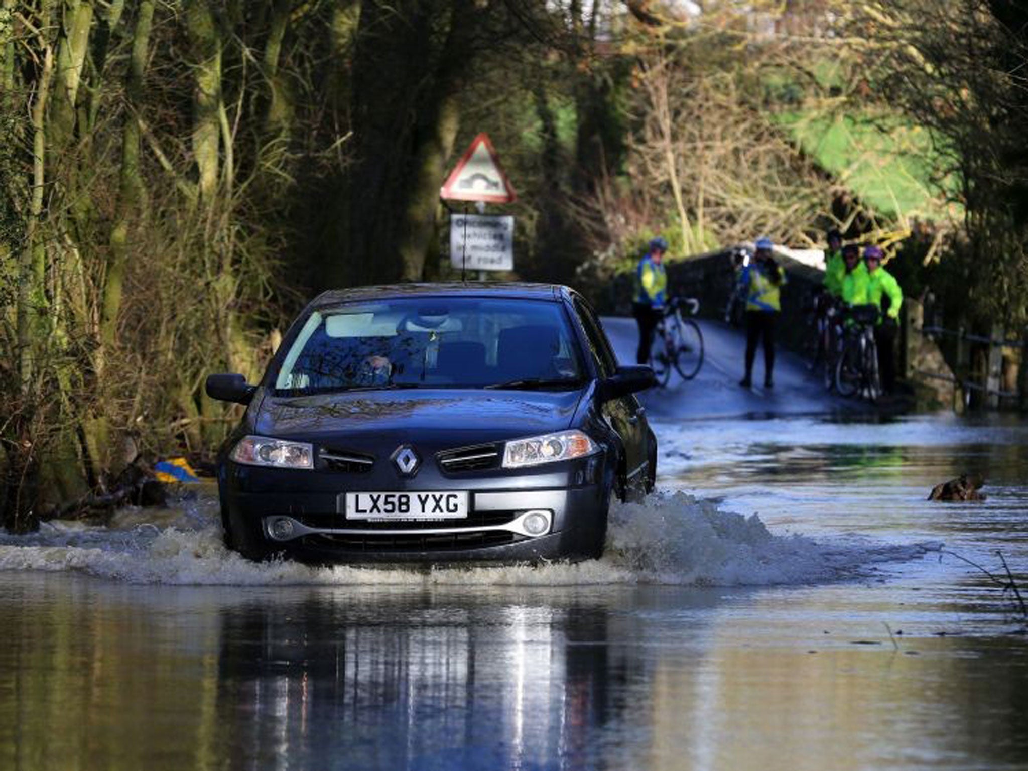 A car tackles flood waters in Kent today, as the threat of more bad weather and flooding continues across the country