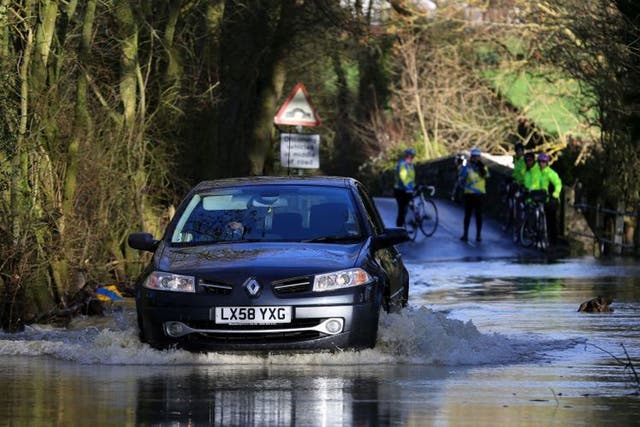 A car tackles flood waters in Kent today, as the threat of more bad weather and flooding continues across the country