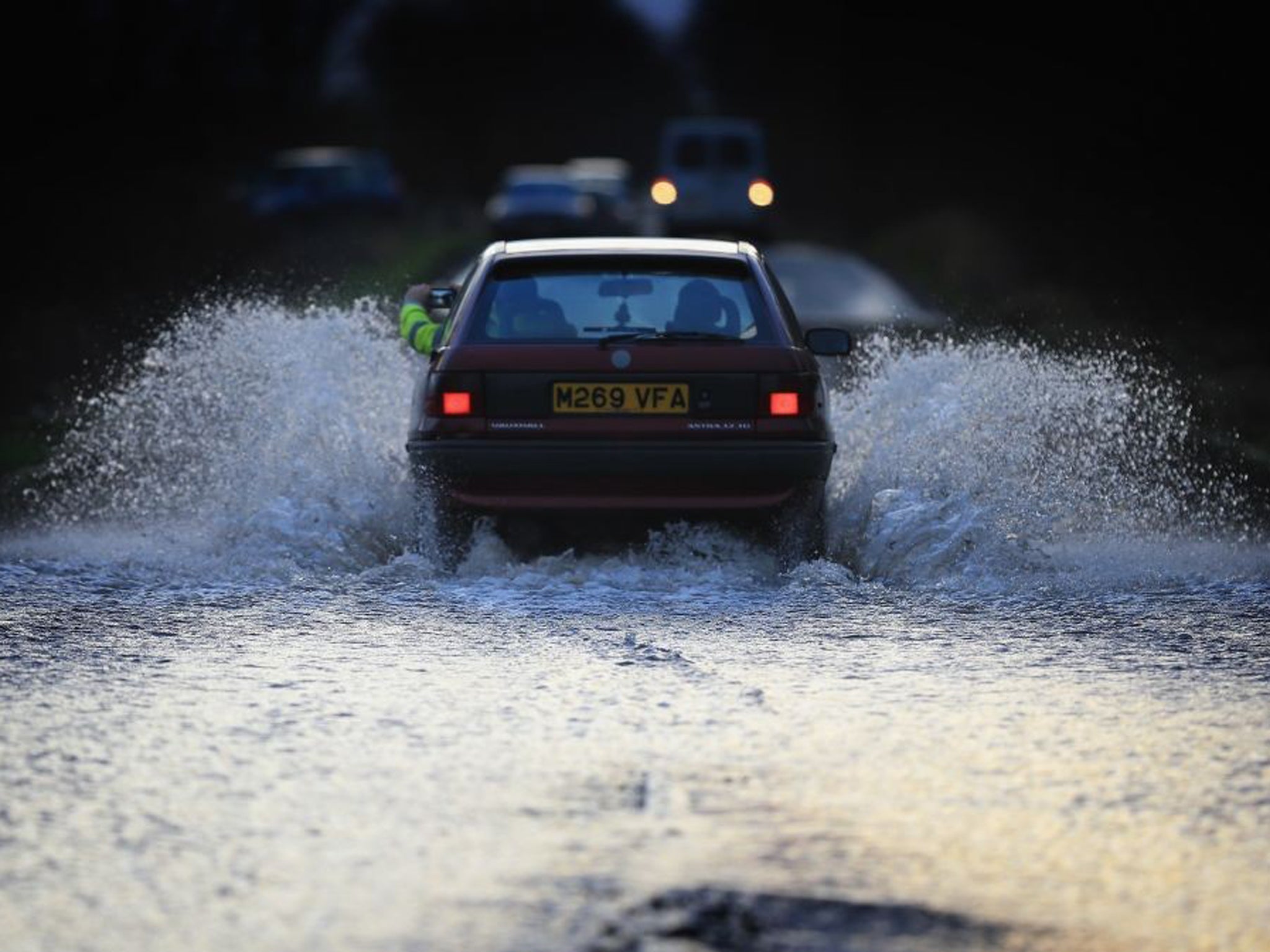 A car drives through flood water on the A361