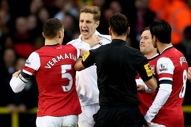 Michael Dawson clashes with Thomas Vermaelen during the north London derby in March 2013