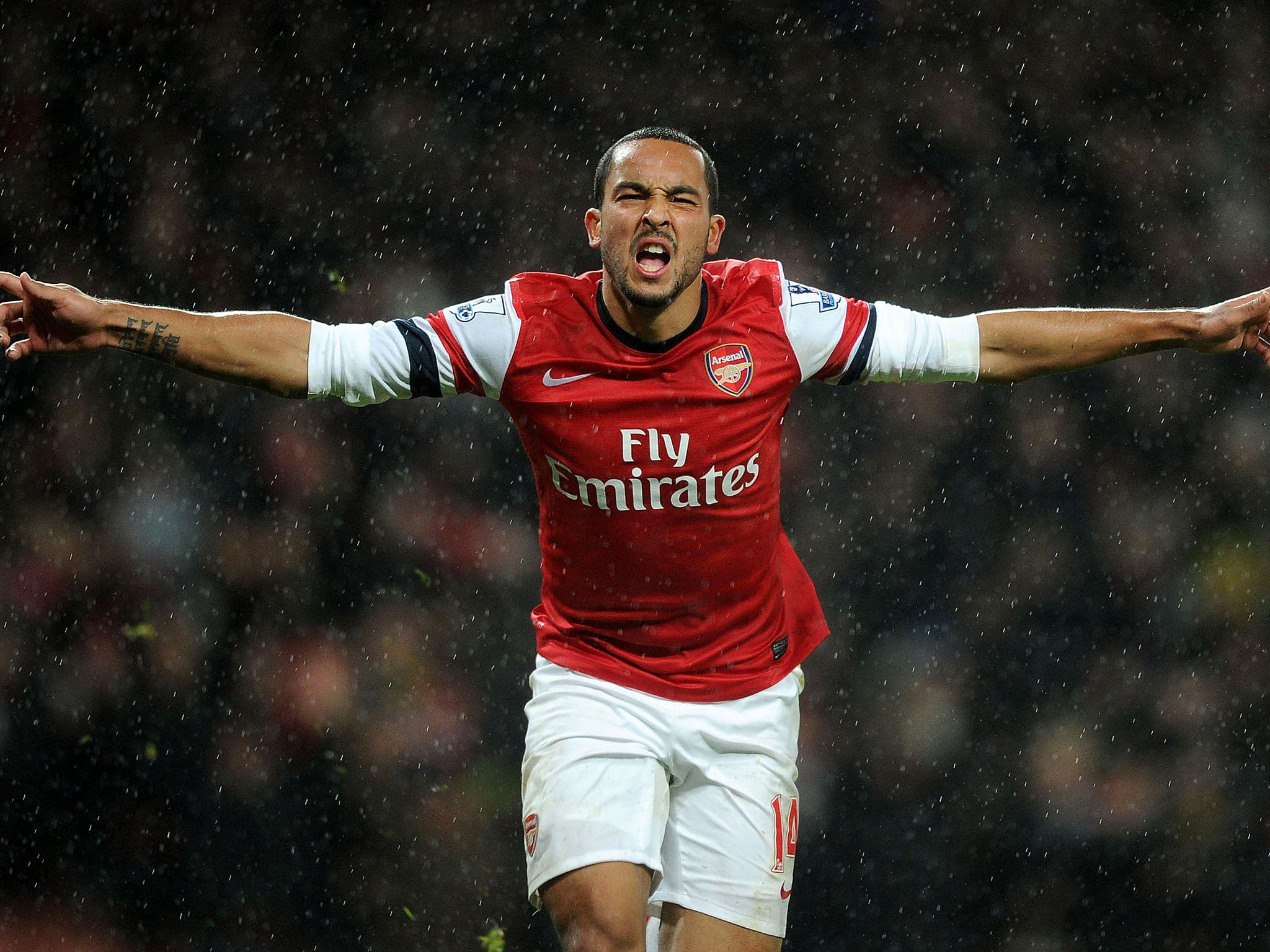 Theo Walcott celebrates after scoring the second goal in the 2-0 victory over Cardiff City