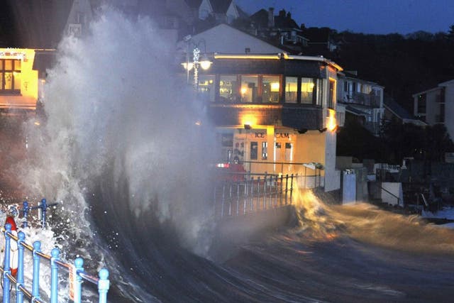 Waves crash over the promenade at hightide in Saundersfoot, in west Wales