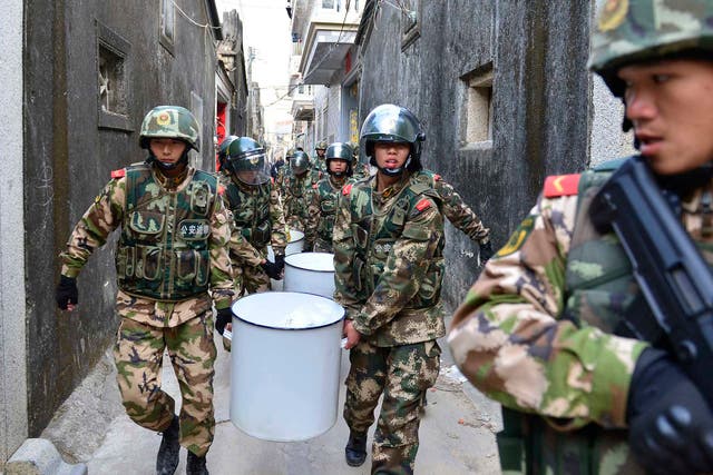 Paramilitary police carry crystal meth at Boshe village, Lufeng, Guangdong province, where they seized nearly three tonnes of the drug and arrested 182