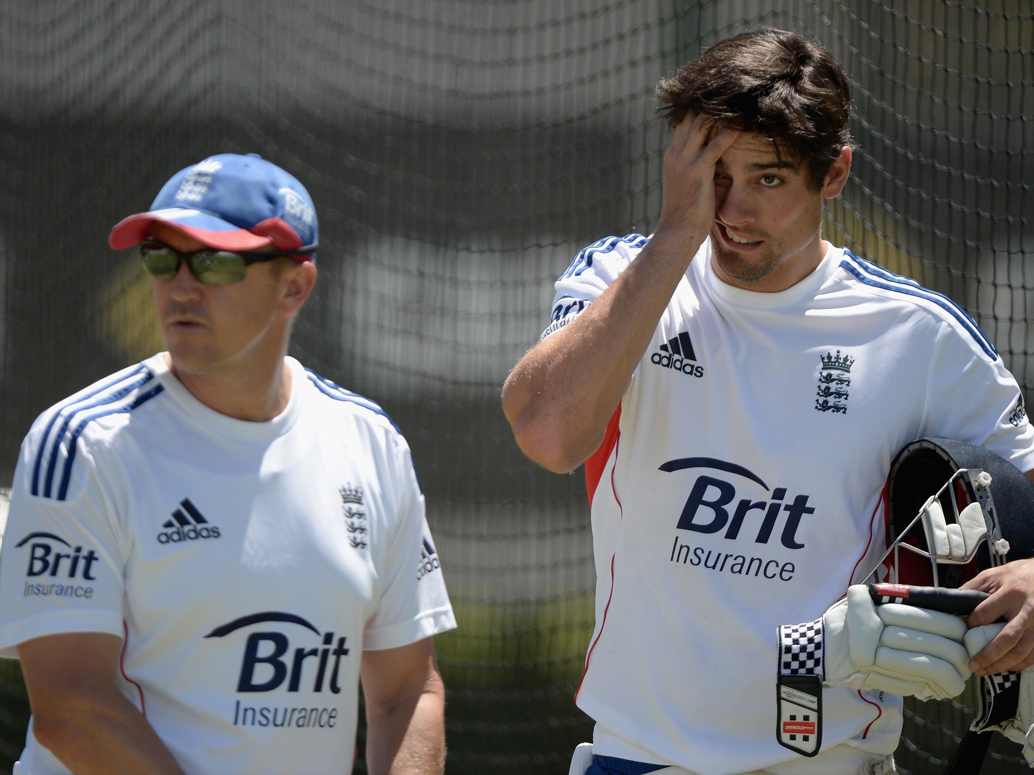 England coach Andy Flower (L) and captain Alastair Cook (R) look set to continue in their roles despite coming under-fire for the dismal Ashes series performance