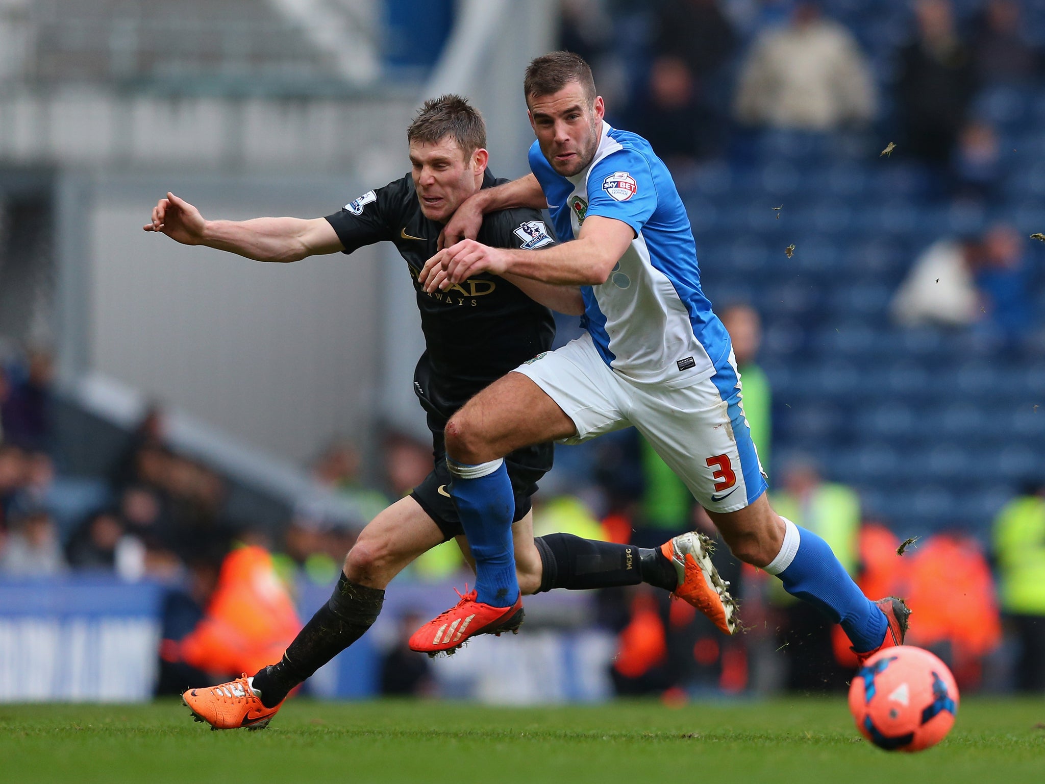 Tommy Spurr of Blackburn Rovers competes with James Milner of Manchester City