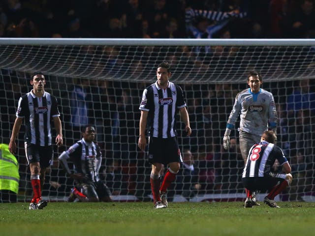 Grimsby players look dejected after conceding a late goal to Huddersfield that saw them knocked out of the FA Cup