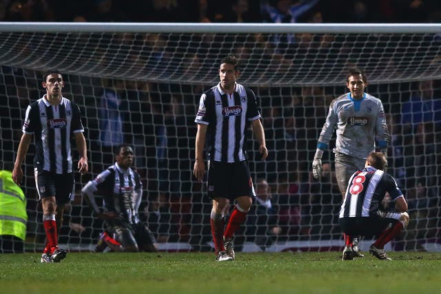 Grimsby players look dejected after conceding a late goal to Huddersfield that saw them knocked out of the FA Cup