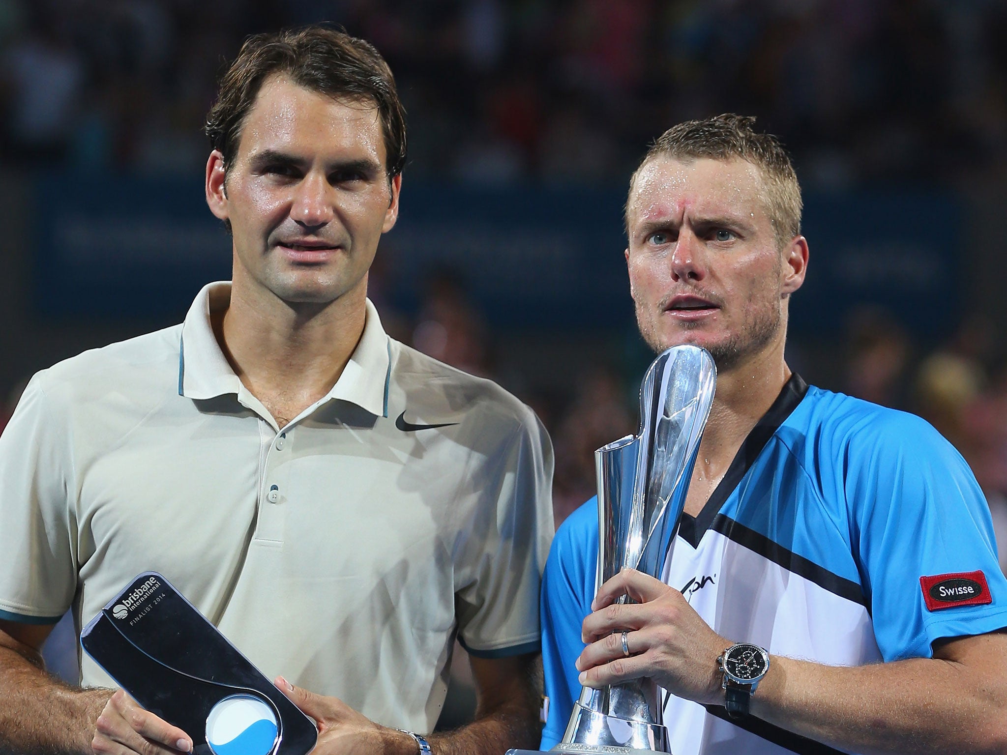 Lleyton Hewitt (right) holds the winners trophy while Roger Federer holds the runner up prize in Brisbane