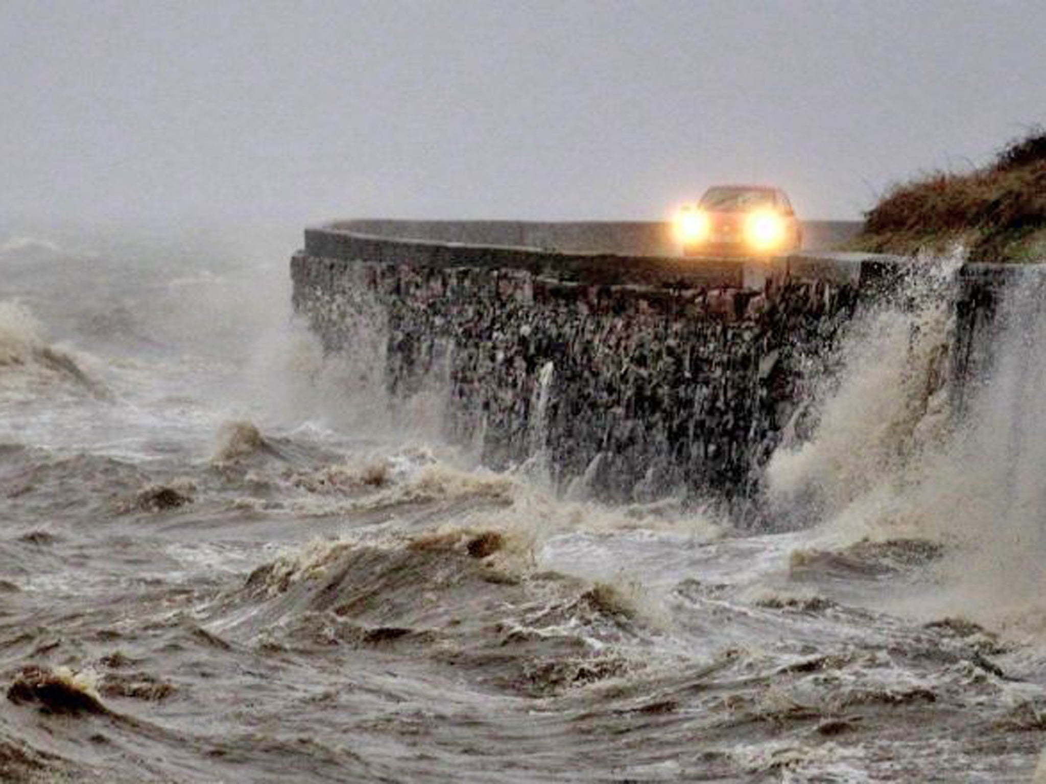 Strong winds and high tides batter the coastal road close to Newtownards, Northern Ireland