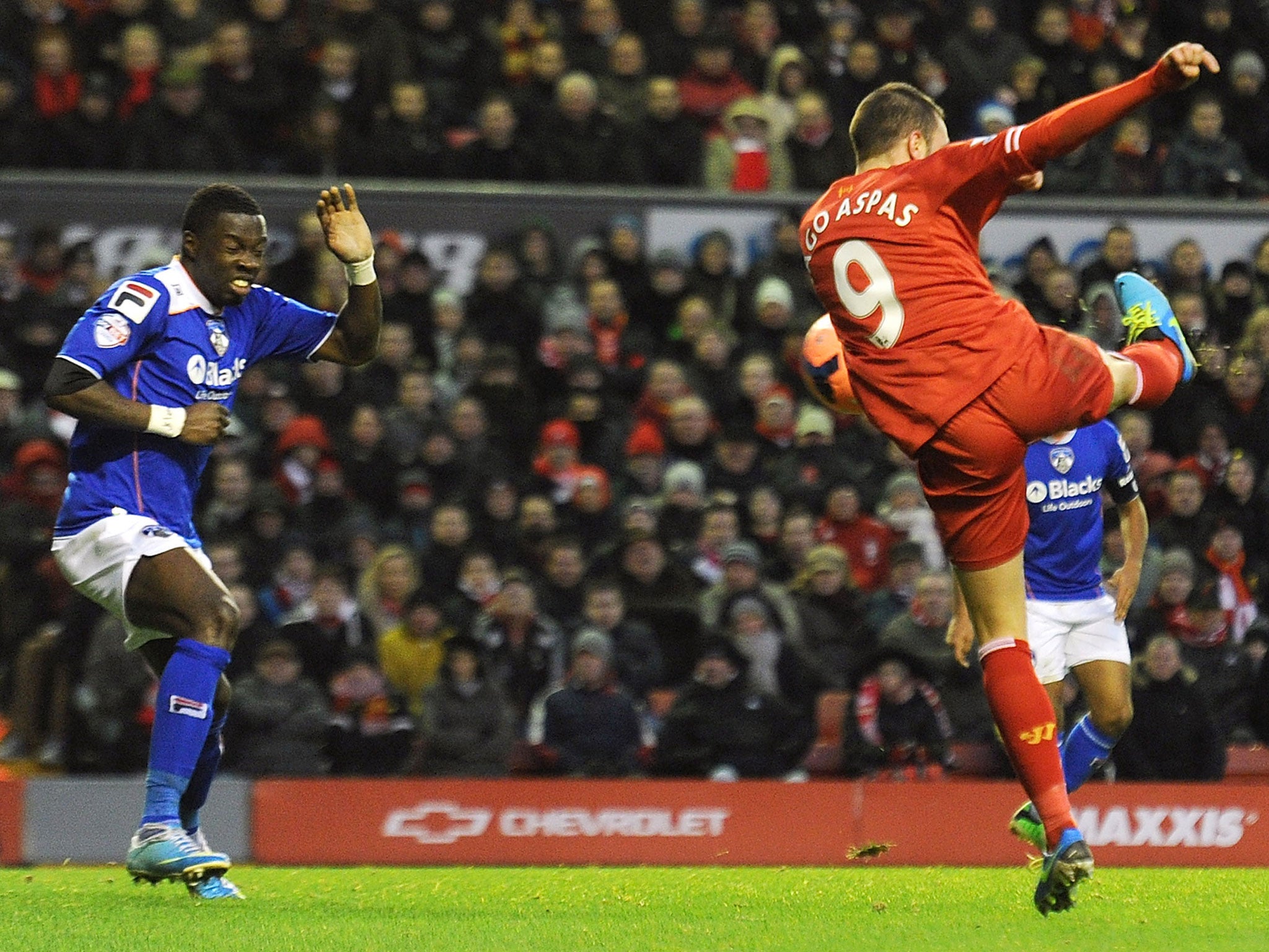 Liverpool's Iago Aspas scores the first goal during their FA Cup Third Round match against Oldham Athletic