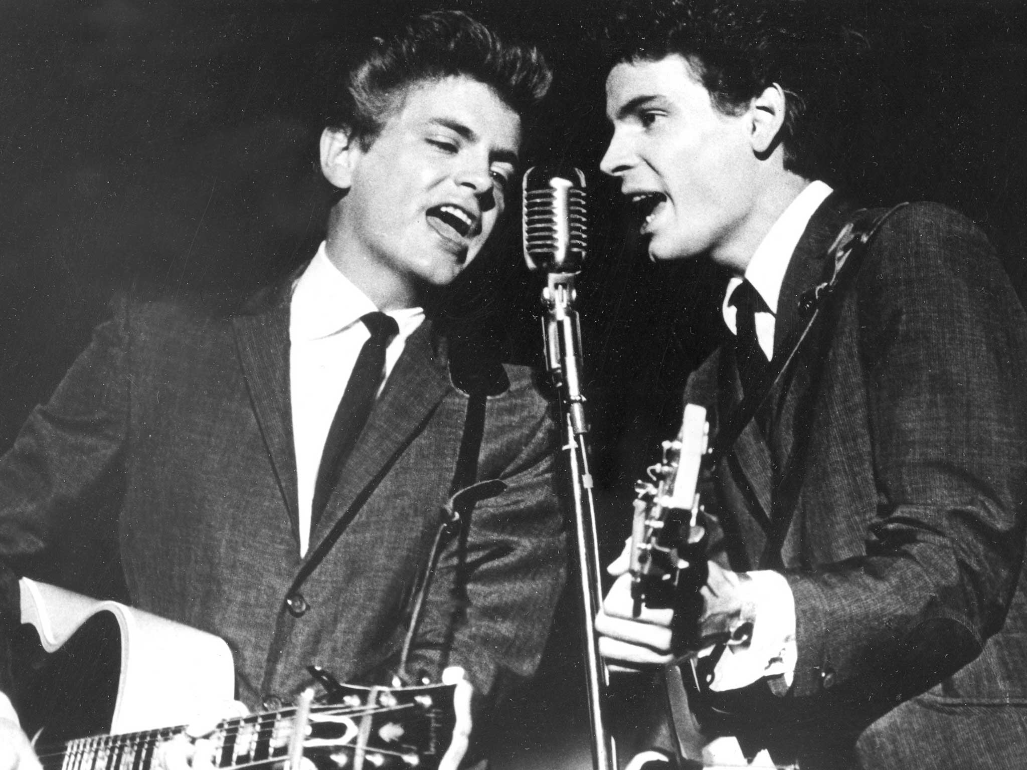 The Everly Brothers, Phil, left, and Don, perform on stage in 1964