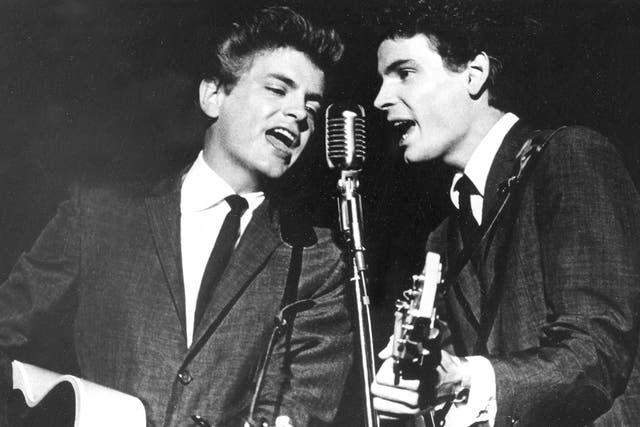 The Everly Brothers, Phil, left, and Don, perform on stage in 1964