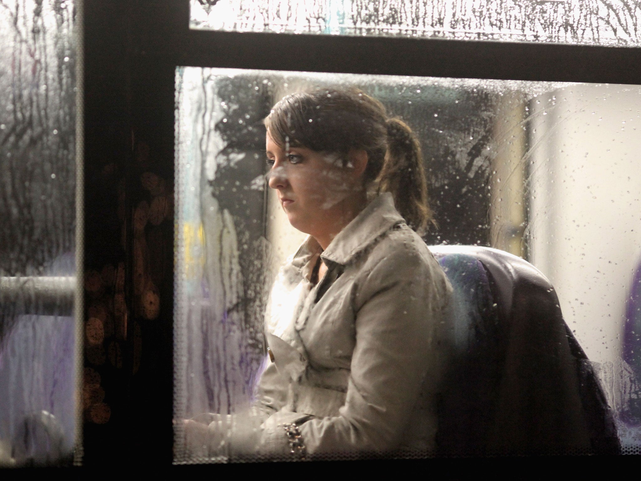 A woman sits on a bus as it makes its way along St Vincent Street