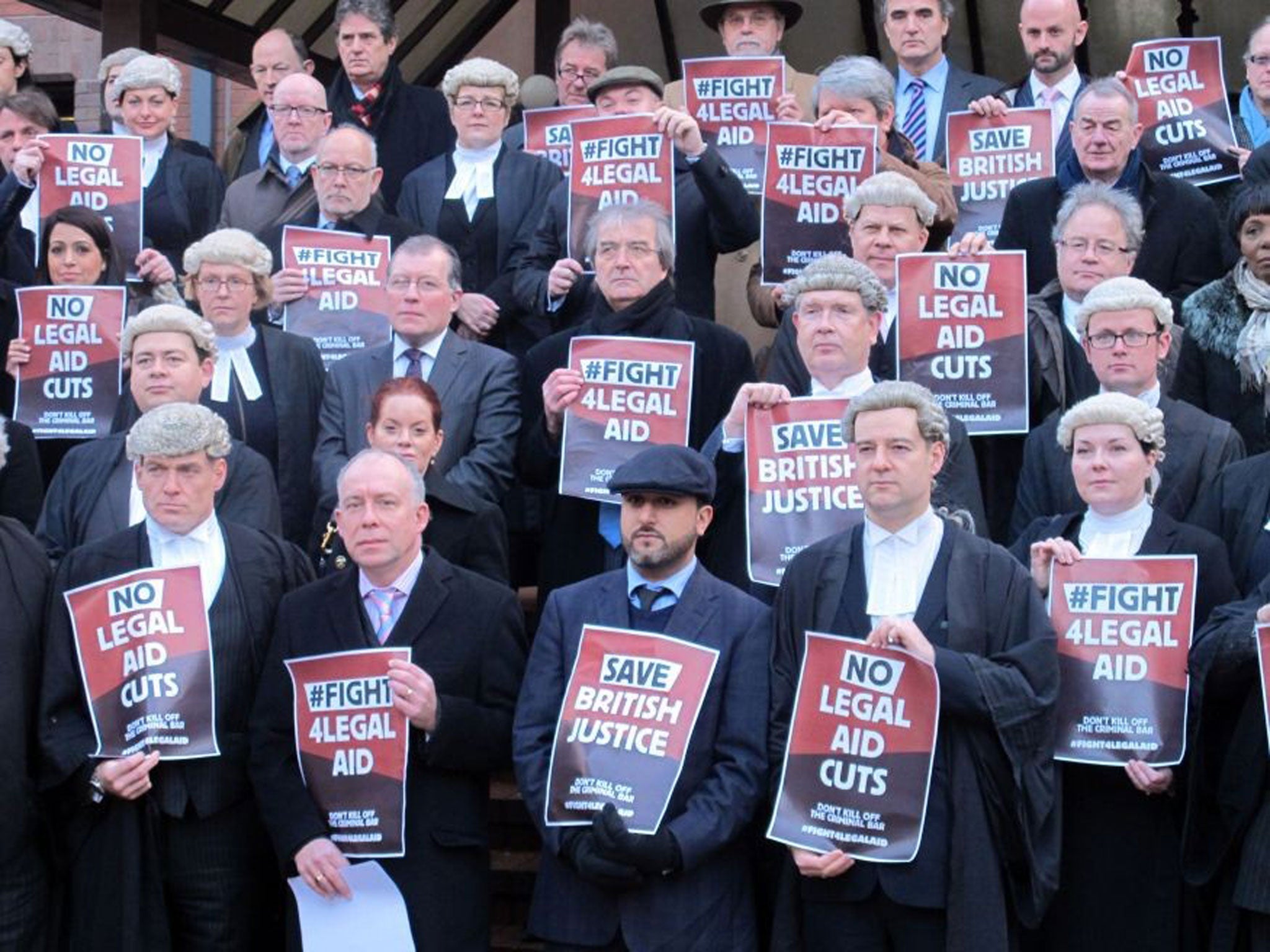 Some of the legal representatives and supporters outside Birmingham Crown Court as barristers around the country stage a walk-out over legal aid cuts