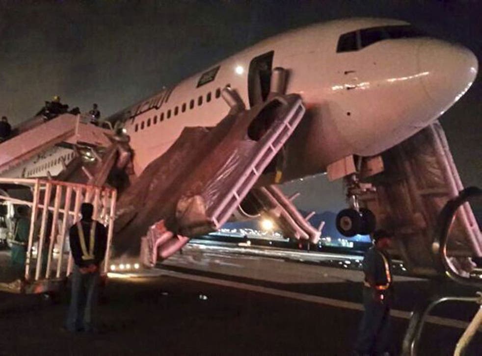 A Saudi Arabian Airlines plane after an emergency landing at Medina airport yesterday. Police were unable to confirm whether the incident was related to human remains that reportedly 'fell from the sky', also early on Sunday
