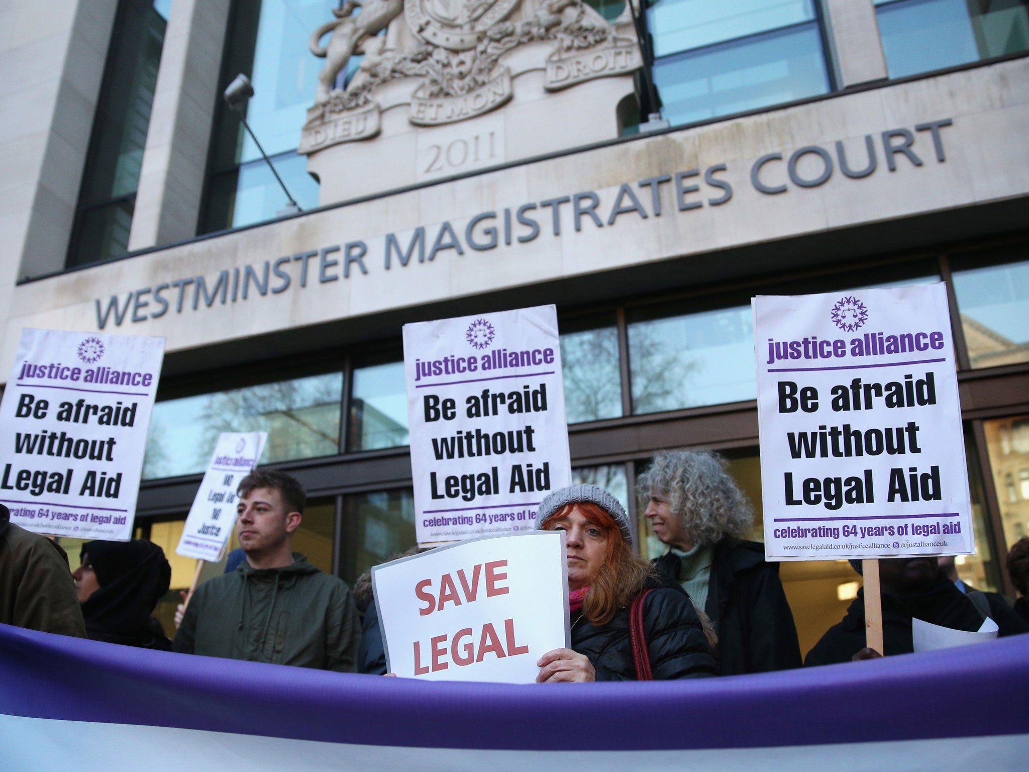 Barristers and solicitors hold a demonstration outside Westminster Magistrates Court against the Government's proposed cuts to legal aid fees last year