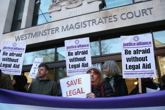 Barristers and solicitors hold a demonstration outside Westminster Magistrates Court against the Government's proposed cuts to legal aid fees last year
