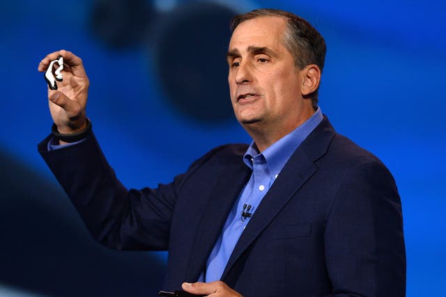 Intel Corp. CEO Brian Krzanich displays the Intel smart headset and earbud designs, providing full stereo audio, heart rate monitor and pulse check, during his keynote address at the 2014 International CES at The Venetian hote