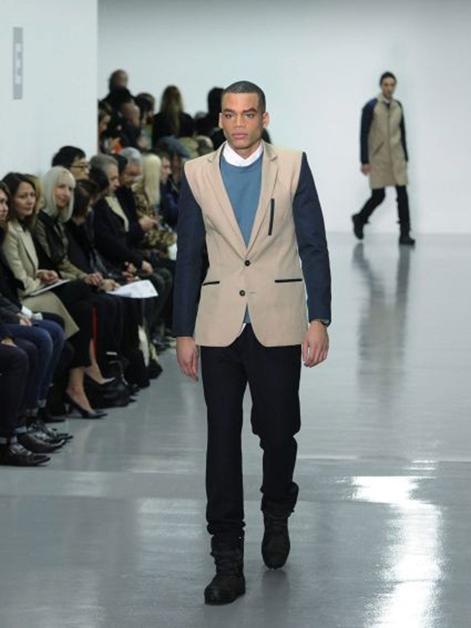 A model presents a creation from the Autumn/Winter 2014 Men's collection by British fashion designer Christopher Raeburn