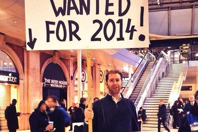 Gerald Abrahams dons his placard at Waterloo station