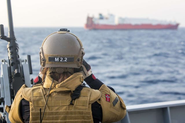 A Norwegian soldier stands guard on one of four Danish and Norwegian vessels deployed to bring Syria's chemical agents to destruction