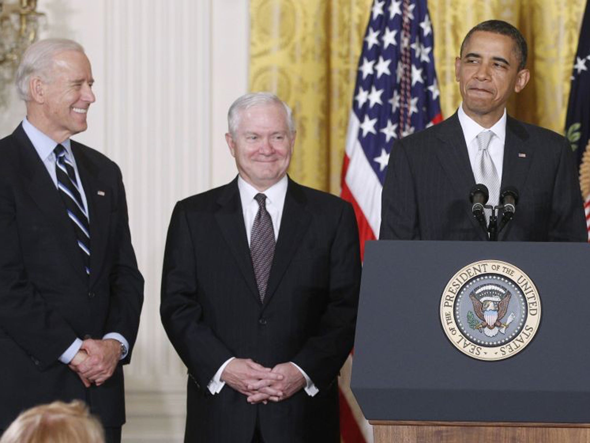 Happier times? April 2011 and President Barack Obama stands in the White House in Washington with Vice President Joe Biden (left) and outgoing Defense Secretary Robert Gates
