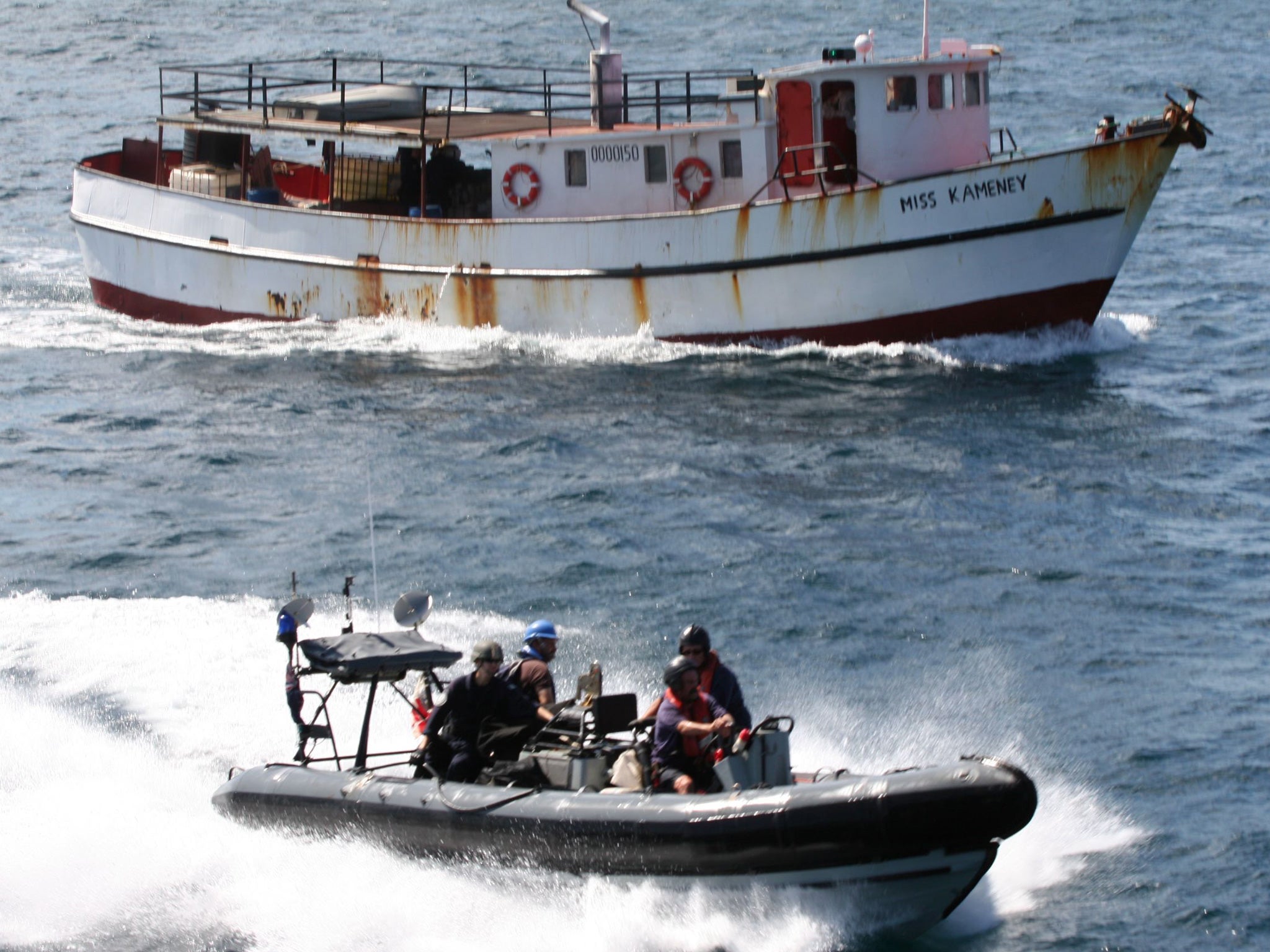 Personnel in a seaboat from RFA Wave Knight escort the suspected drug-carrying vessel