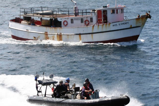 Personnel in a seaboat from RFA Wave Knight escort the suspected drug-carrying vessel