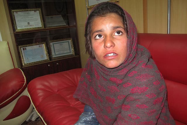 Spozhmai, 10, who was about to be used by the Taliban as a suicide bomber, talks as she sits at a police office in Helmand province on 6 January 2014