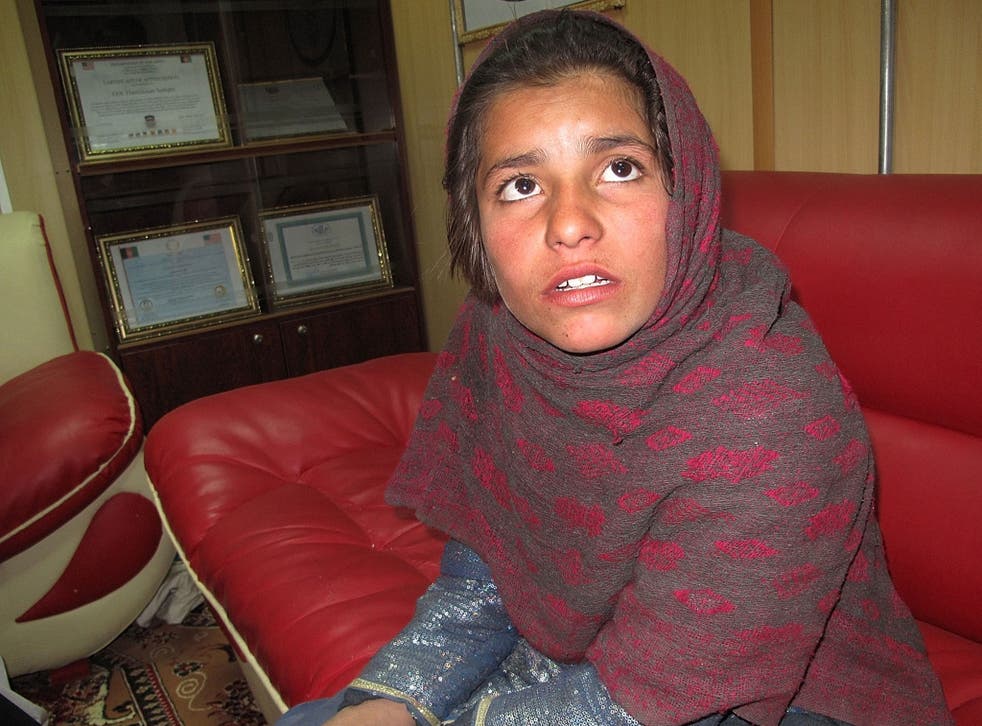Spozhmai, 10, who was about to be used by the Taliban as a suicide bomber, talks as she sits at a police office in Helmand province on 6 January 2014