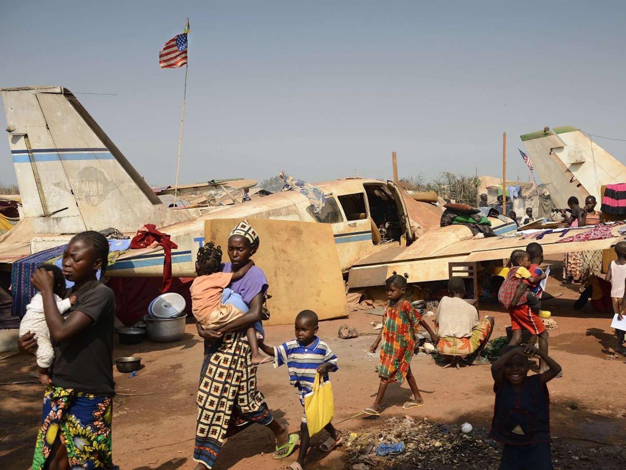 Displaced people in an aero-club area near Mpoko Bangui airport where 100,000 people have fled