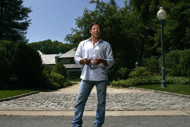 Jordan Belfort stands outside his former home
