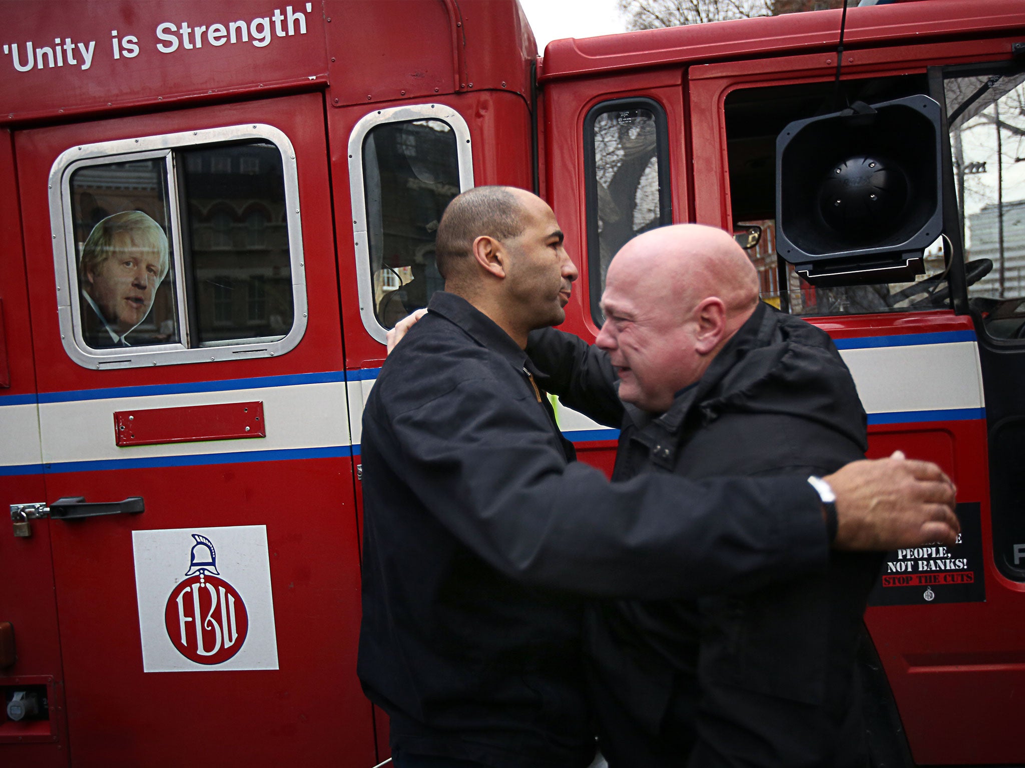 Fireman Christian McClean comforts colleague Alex Badcock (right) after they both finished the last ever shift at Clerkenwell fire station in London.