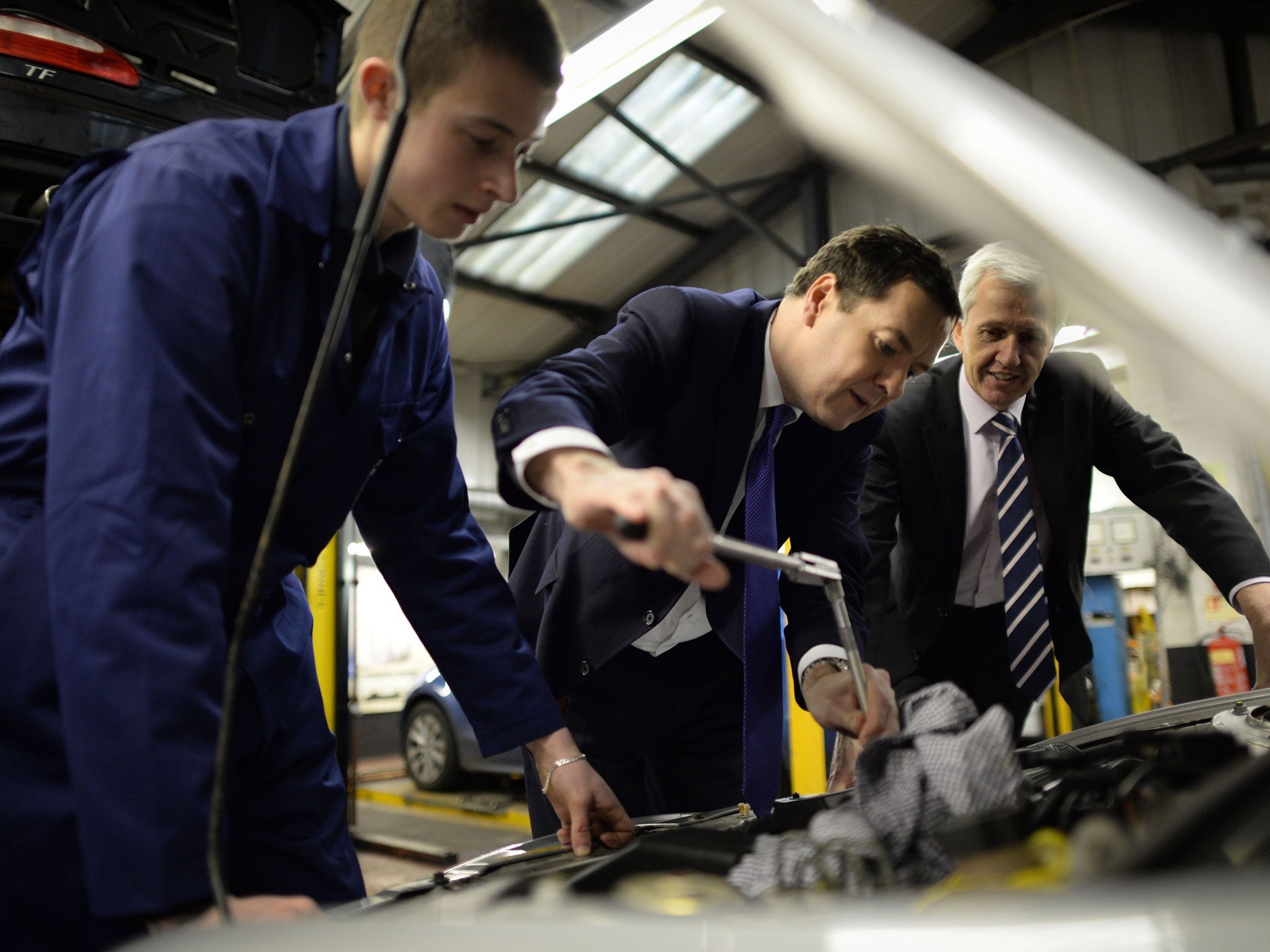 Chancellor George Osborne shows off his mechanical abilities during a visit to a garage in Enfield, north London