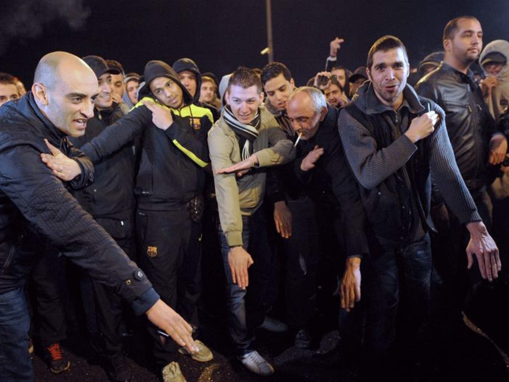 Fans perform the 'quenelle' salute after the performance of French controversial humorist Dieudonne M'bala M'bala was cancelled