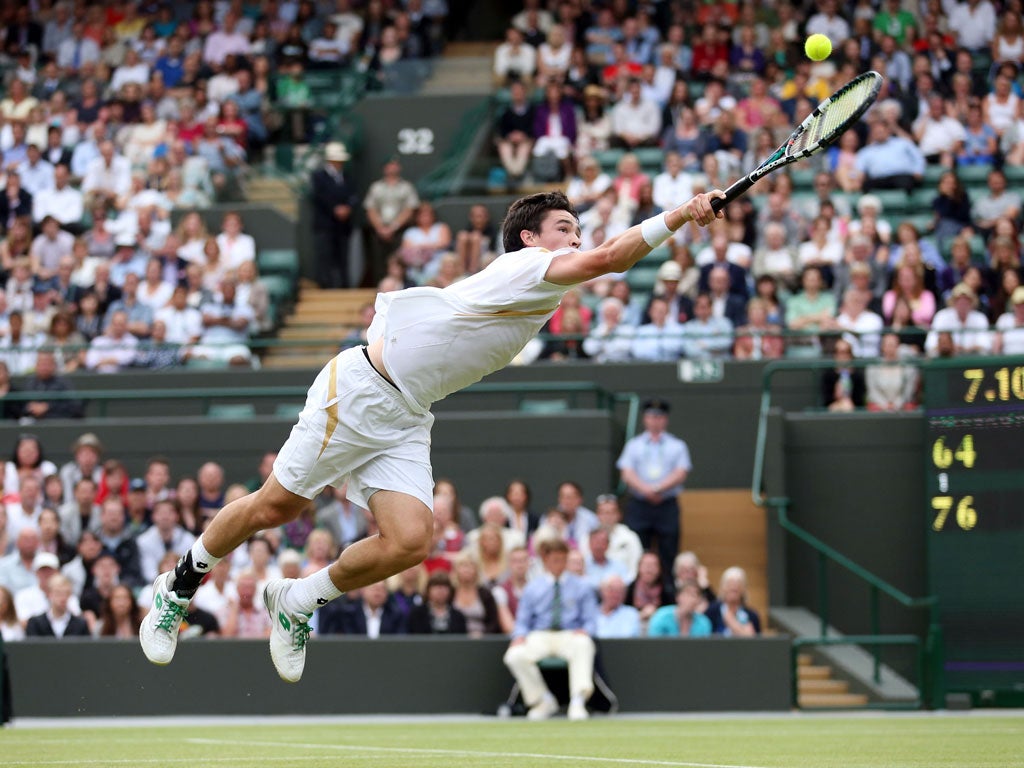 Jamie Baker dives for a backhand against Andy Roddick at Wimbledon, 2012