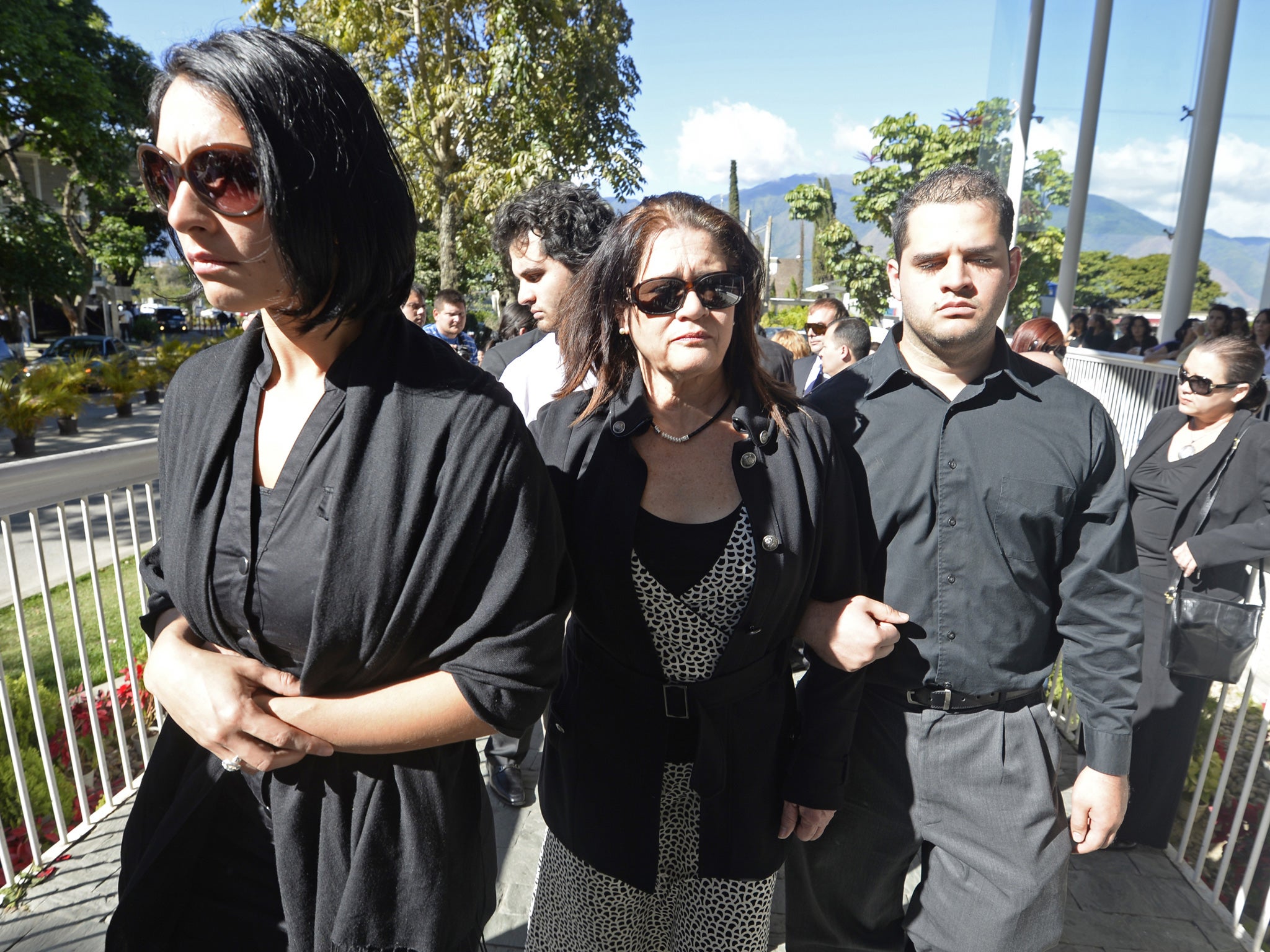 Carolina Spear (left), sister, and Ingeborg Mootz de Spear (centre) mother of late Venezuelan model Monica Spear, head for the chapel in a cemetery east of Caracas