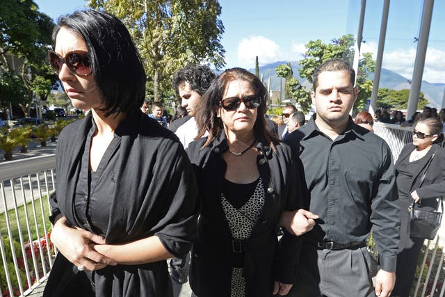 Carolina Spear (left), sister, and Ingeborg Mootz de Spear (centre) mother of late Venezuelan model Monica Spear, head for the chapel in a cemetery east of Caracas