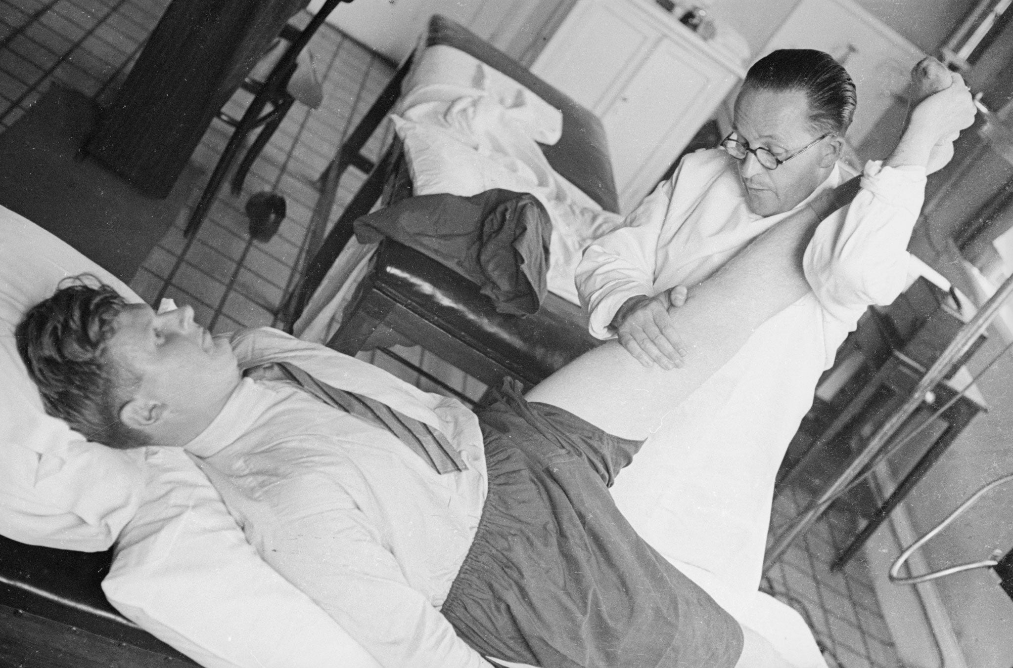 An osteopath manipulates a patient's joints at the British School of Osteopathy in London, in 1940