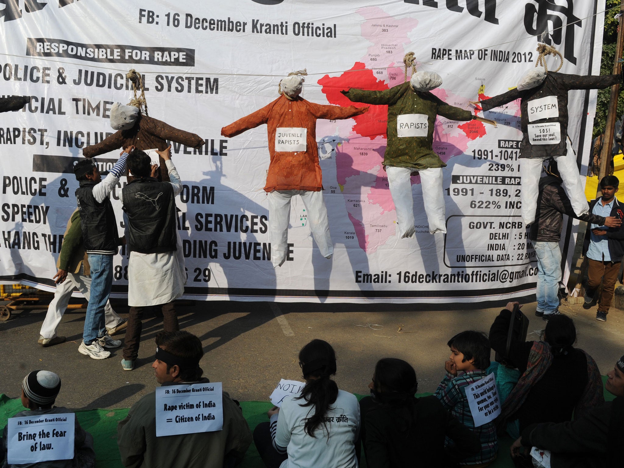 Demonstrators gather near effigies representing the convicted rapists during a protest in New Delhi in December 2013