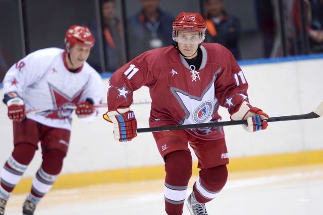 President Vladimir Putin, who has backed the £30bn Games, with the Russia ice hockey team in Sochi 
