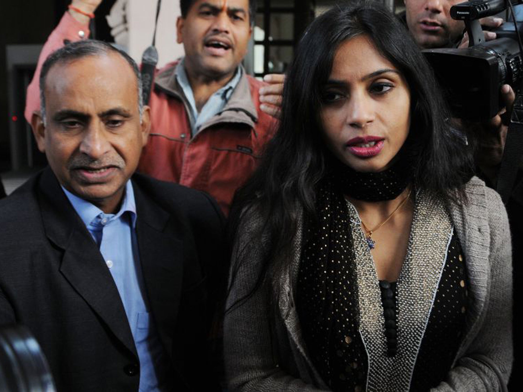 Indian diplomat Devyani Khobragade arrived in New Delhi on Friday night, where she was met by her father (left)
