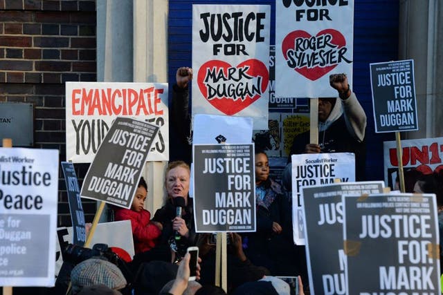 Carole Duggan (L), aunt of Mark Duggan who was shot dead by police, addresses the gathering outside Tottenham Police Station in London on 11 January, 2014, 