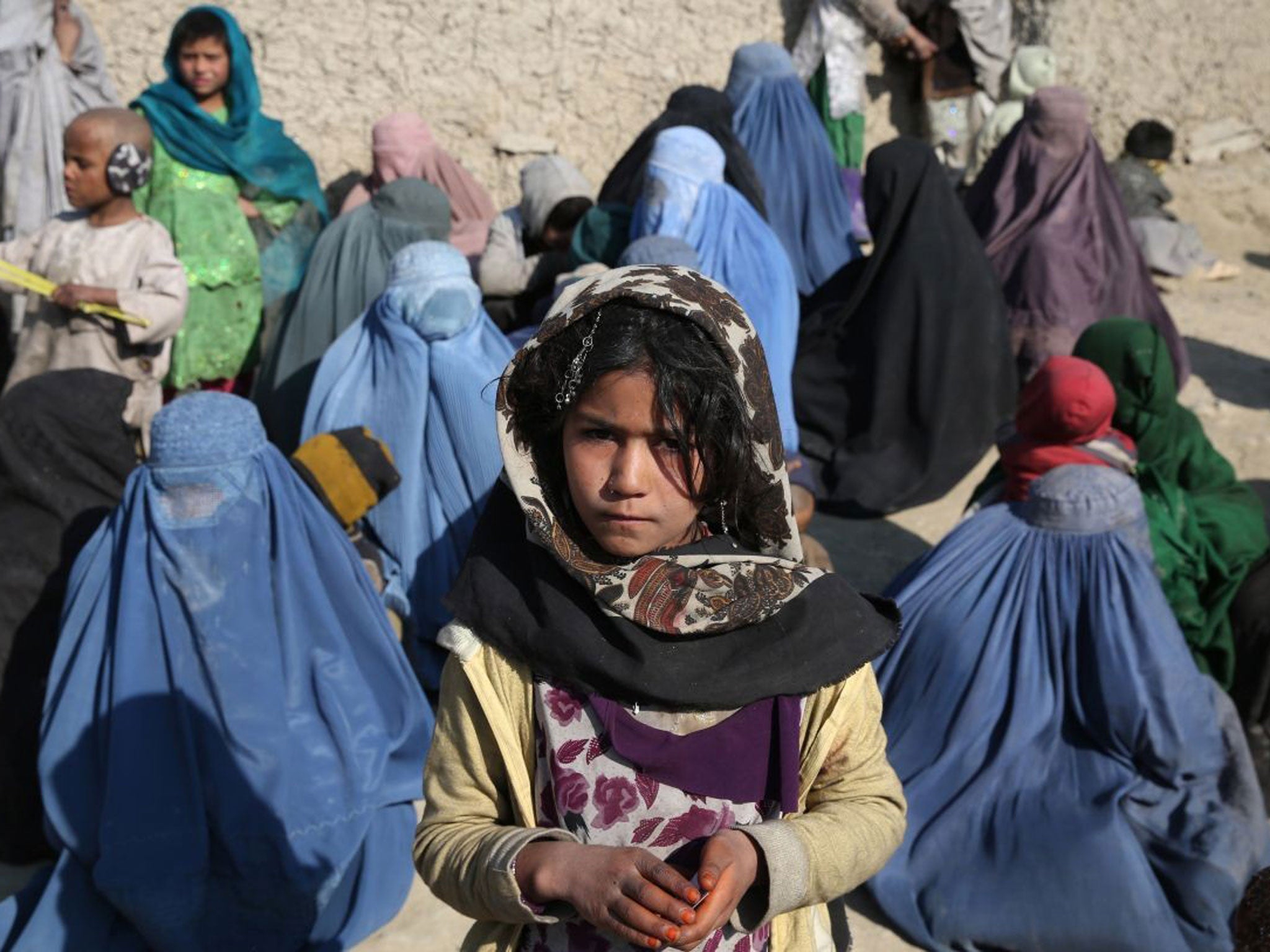 Cold comfort: Afghans wait to receive winter aid in Kabul last weekend