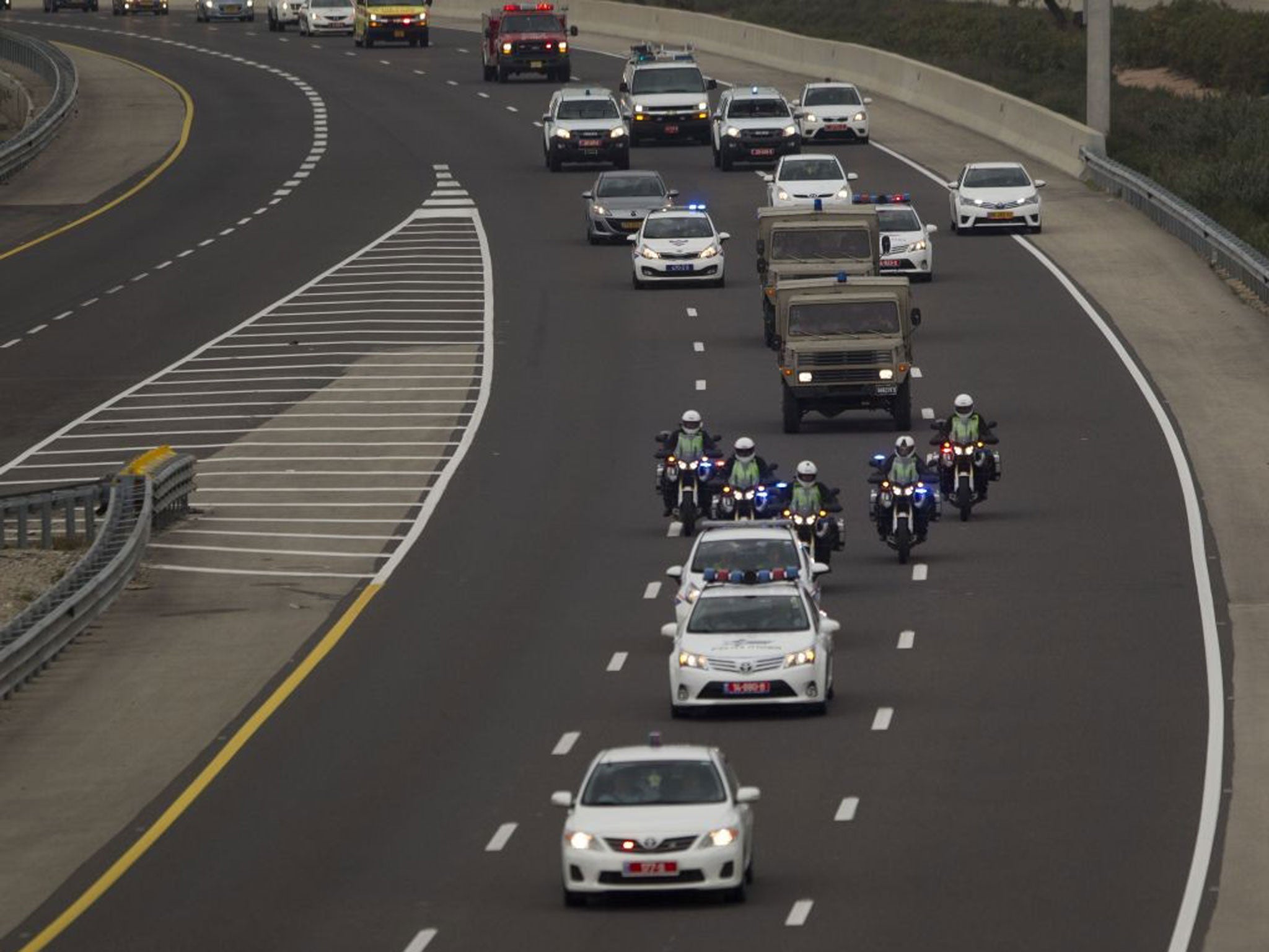 A military convoy takes the body of Ariel Sharon to Jerusalem from a base near Rishon Letzion in central Israel