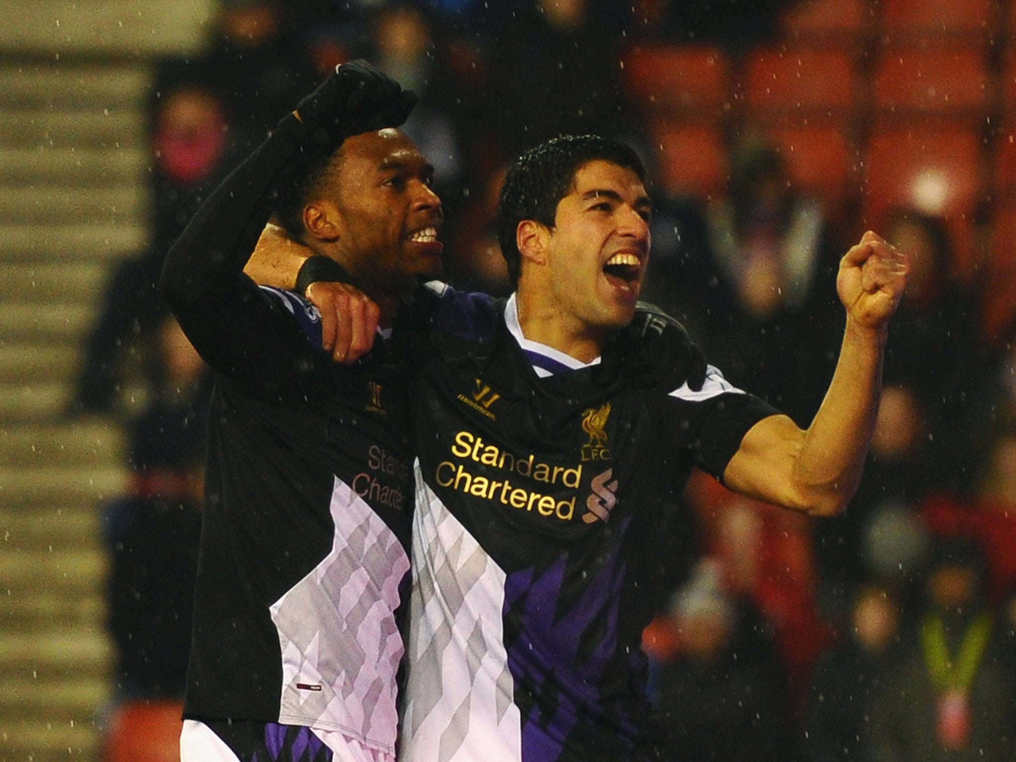 Luis Suarez of Liverpool celebrates with Daniel Sturridge (L) as he scores their fourth goal during the Barclays Premier League match against Stoke