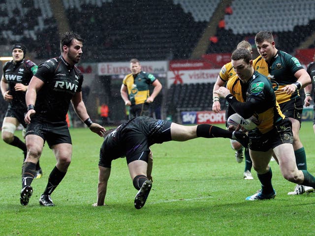 George North of Northampton brushes off the challenge  of Ospreys’ Jeff Hassler