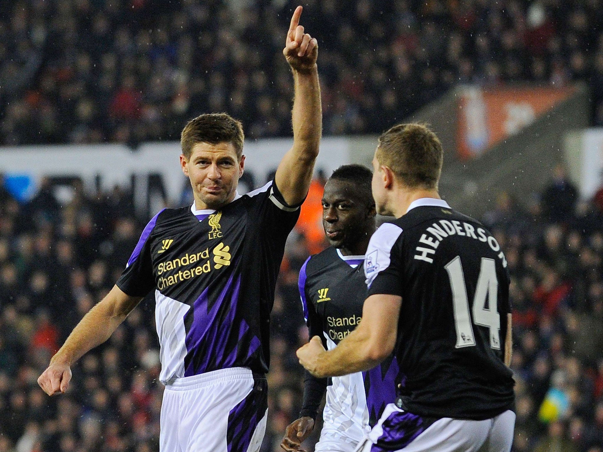 Liverpool’s Steven Gerrard, left, celebrates scoring from the spot
