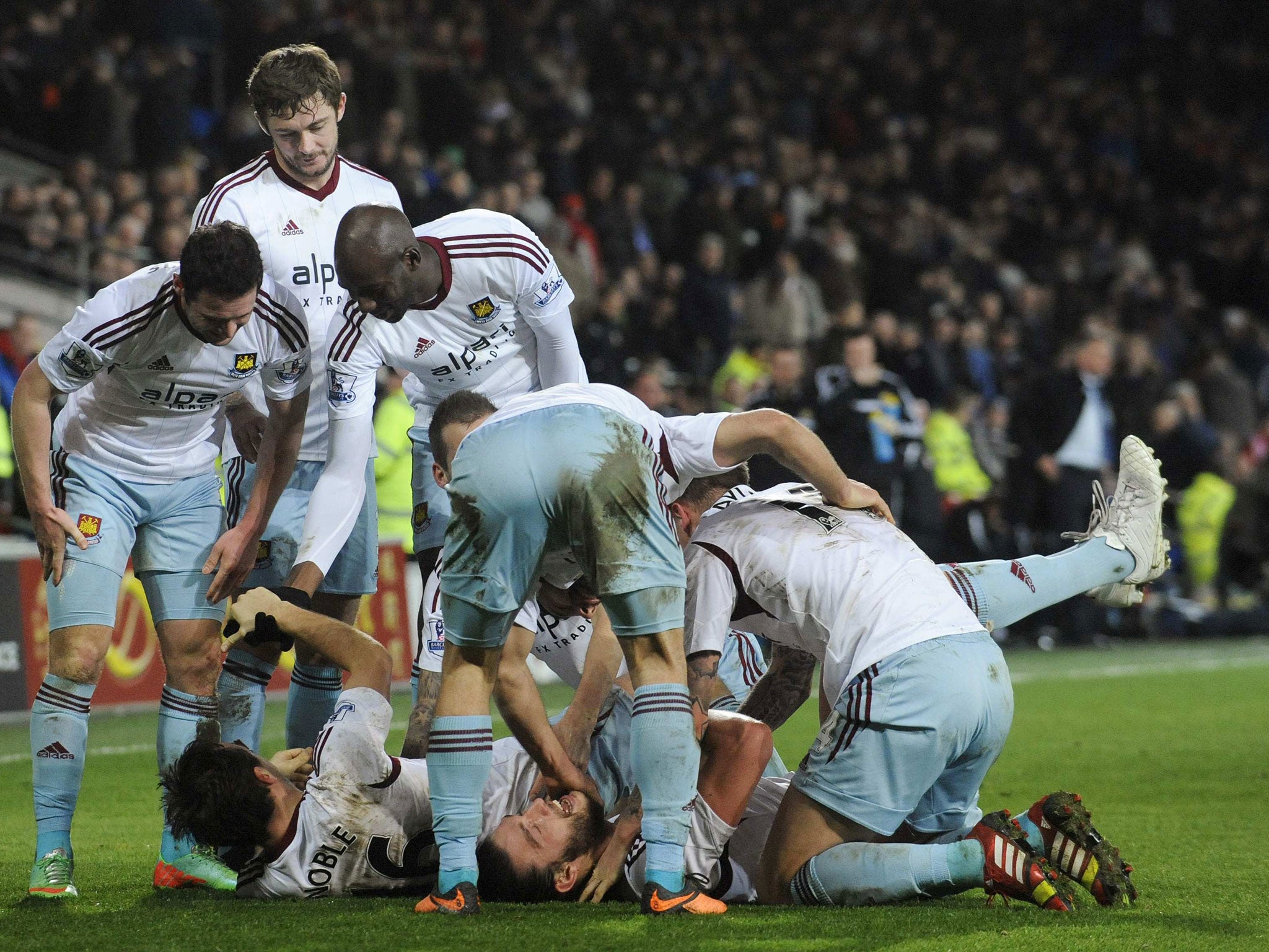 West Ham players celebrate Mark Noble’s late goal at Cardiff