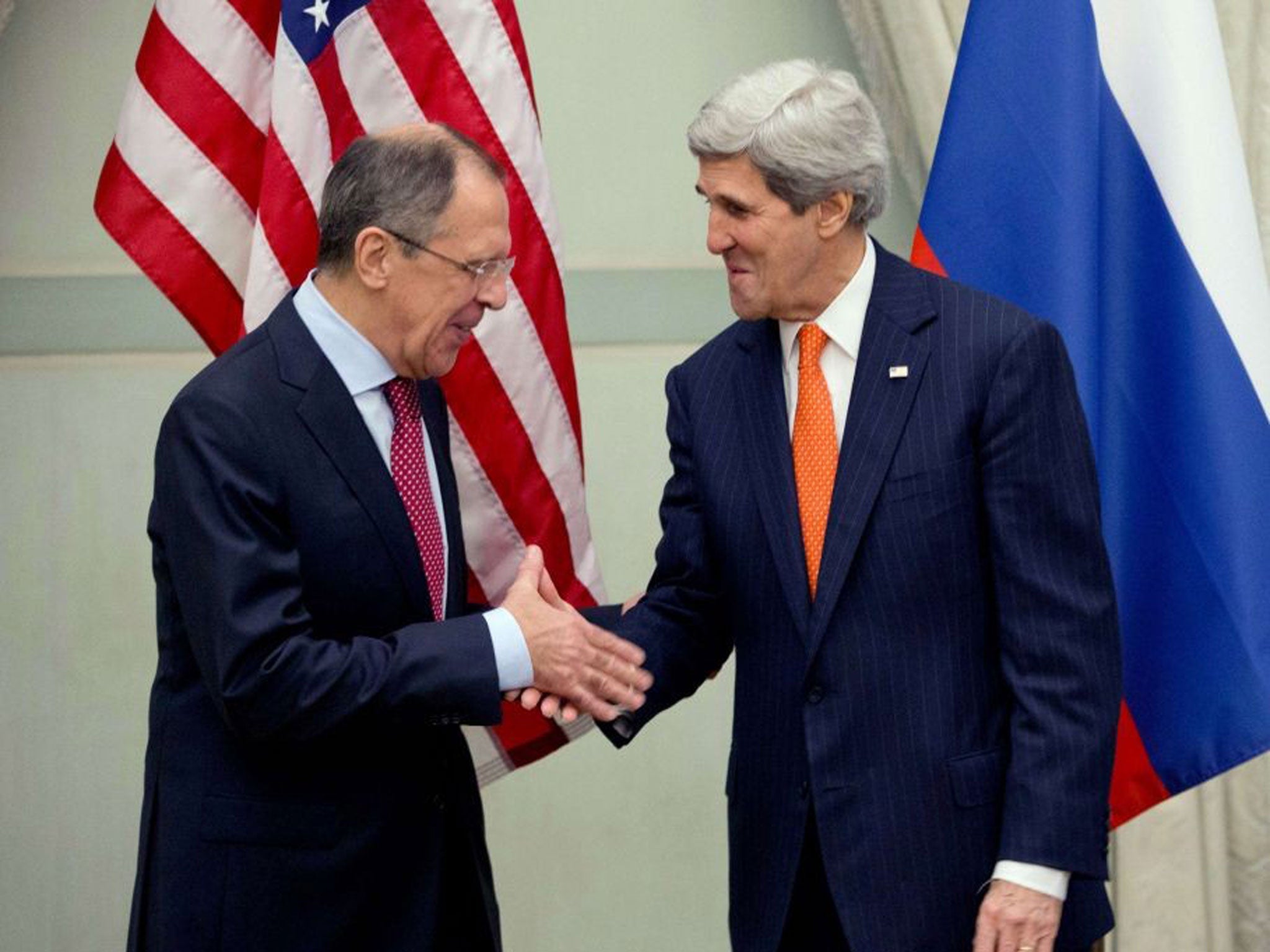 US Secretary of State John Kerry (R) shakes hands with Russia's Foreign Minister Sergei Lavrov before the start of their meeting in Paris, 13 January 2014